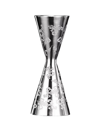A stainless steel jigger with floral engravings on the side, featuring a narrow waist and additional notches for measurement.