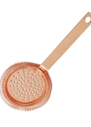A gold-colored stainless steel Hawthorne strainer with a perforated circular head and a handle.