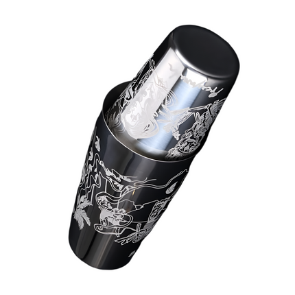 Metallic cylindrical object with engraved designs on a black background