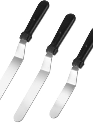 Set of four metal spatulas with black handles on a white background