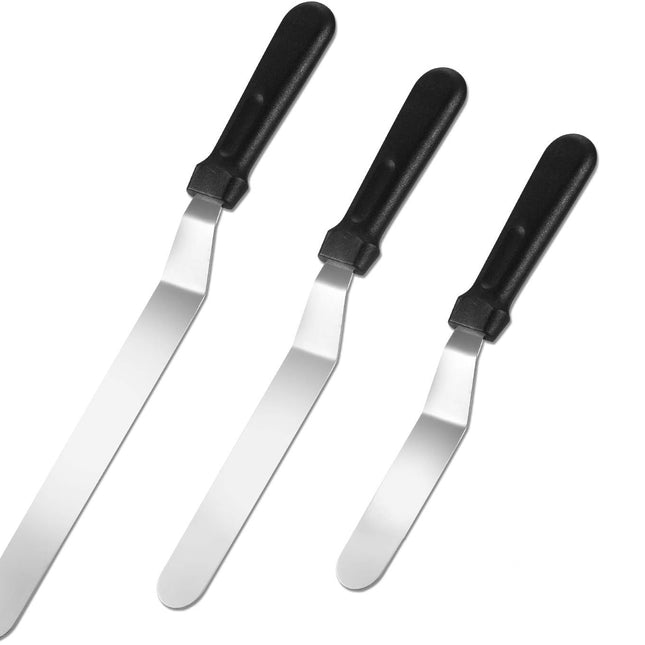 Set of four metal spatulas with black handles on a white background