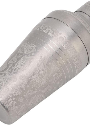 Decorative metal object with intricate engravings on a white background