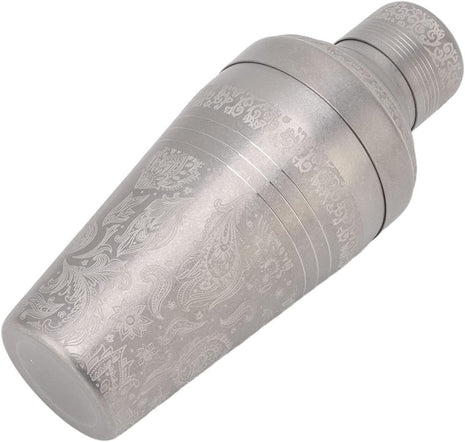 Decorative metal object with intricate engravings on a white background