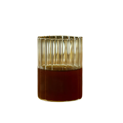 Glass candle holder with a metallic rim on a white background