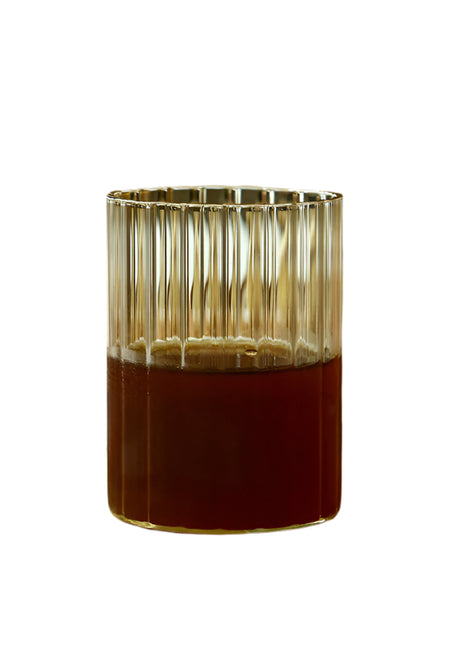 Glass candle holder with a metallic rim on a white background