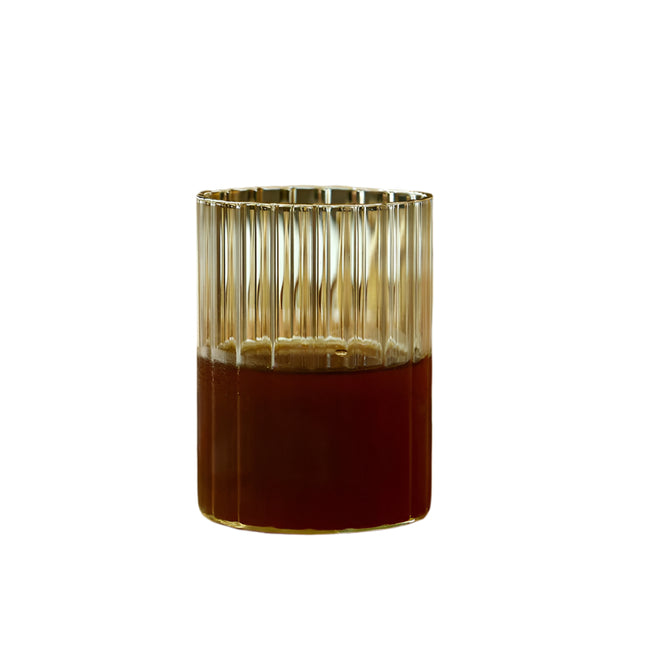 Glass candle holder with a metallic rim on a white background