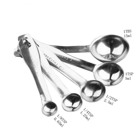 Set of stainless steel measuring spoons with measurements on a white background