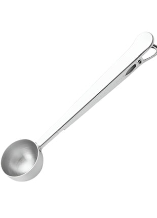Metal measuring spoon on a white background