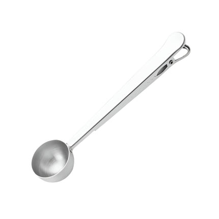 Metal measuring spoon on a white background