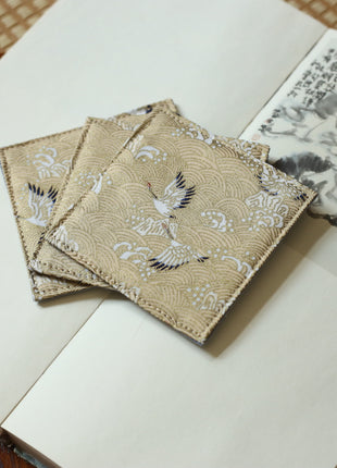 Fabric Coaster — Beige base with cranes (9×9 cm)