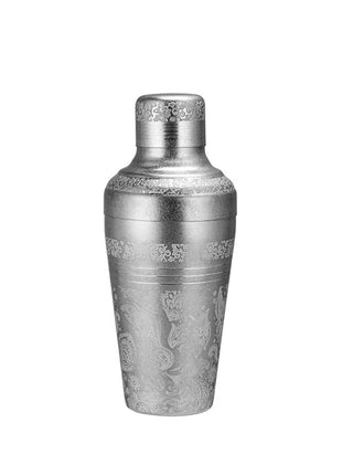 Decorative silver cocktail shaker on a white background with a brand logo at the top.