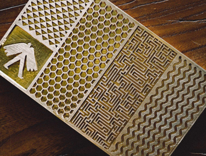 Decorative tile with geometric patterns on a wooden surface